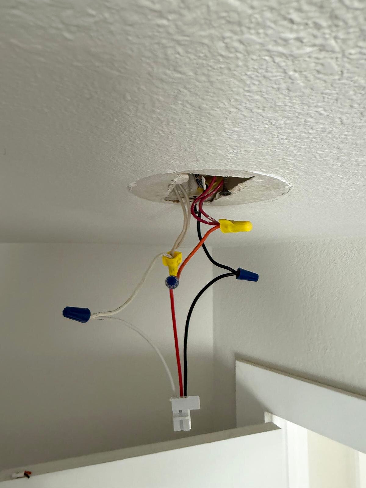 Closer view of the ceiling junction box wiring, wire nuts and connector prepped for the new fixture