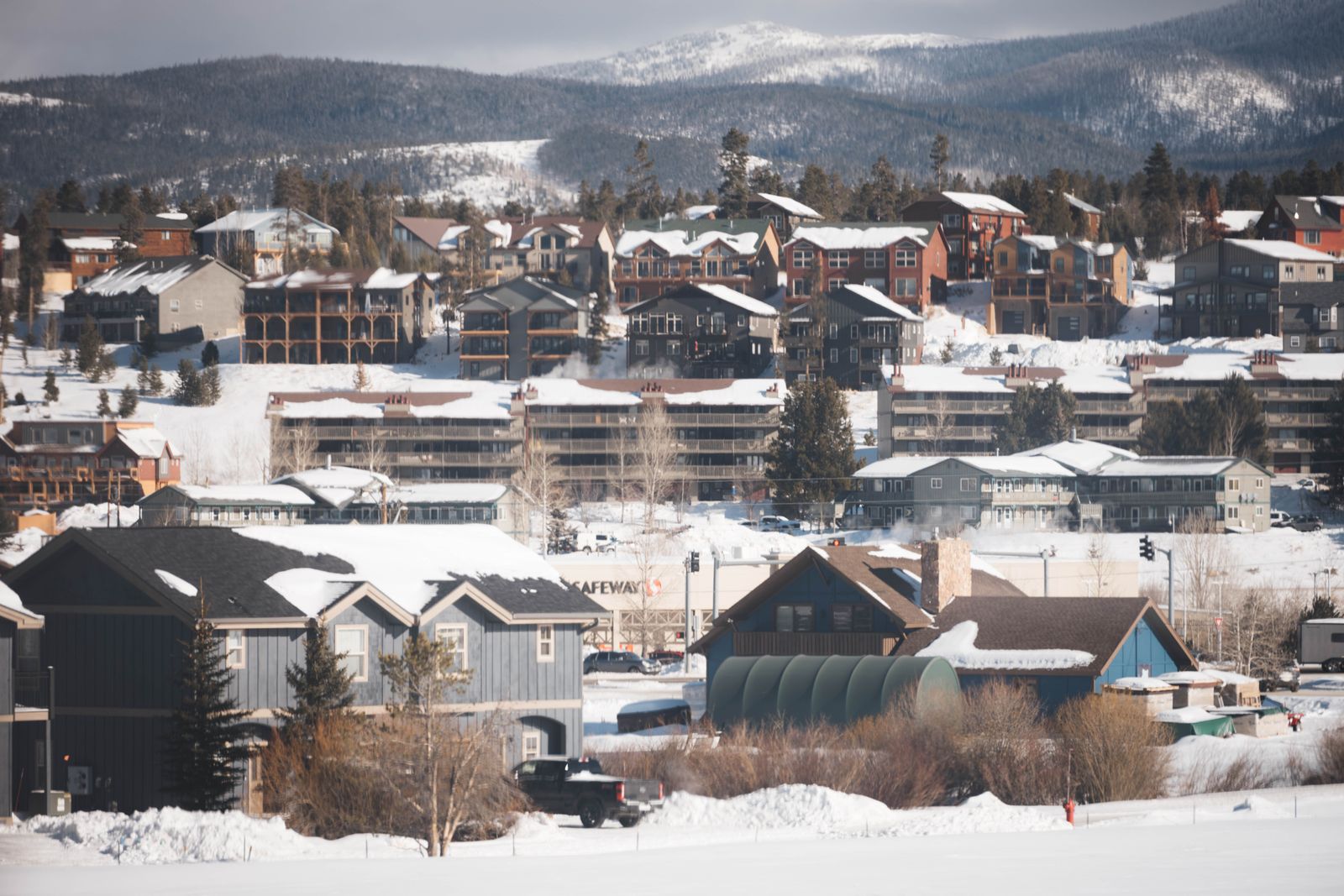 Snow-covered suburban Colorado homes with mountain backdrop