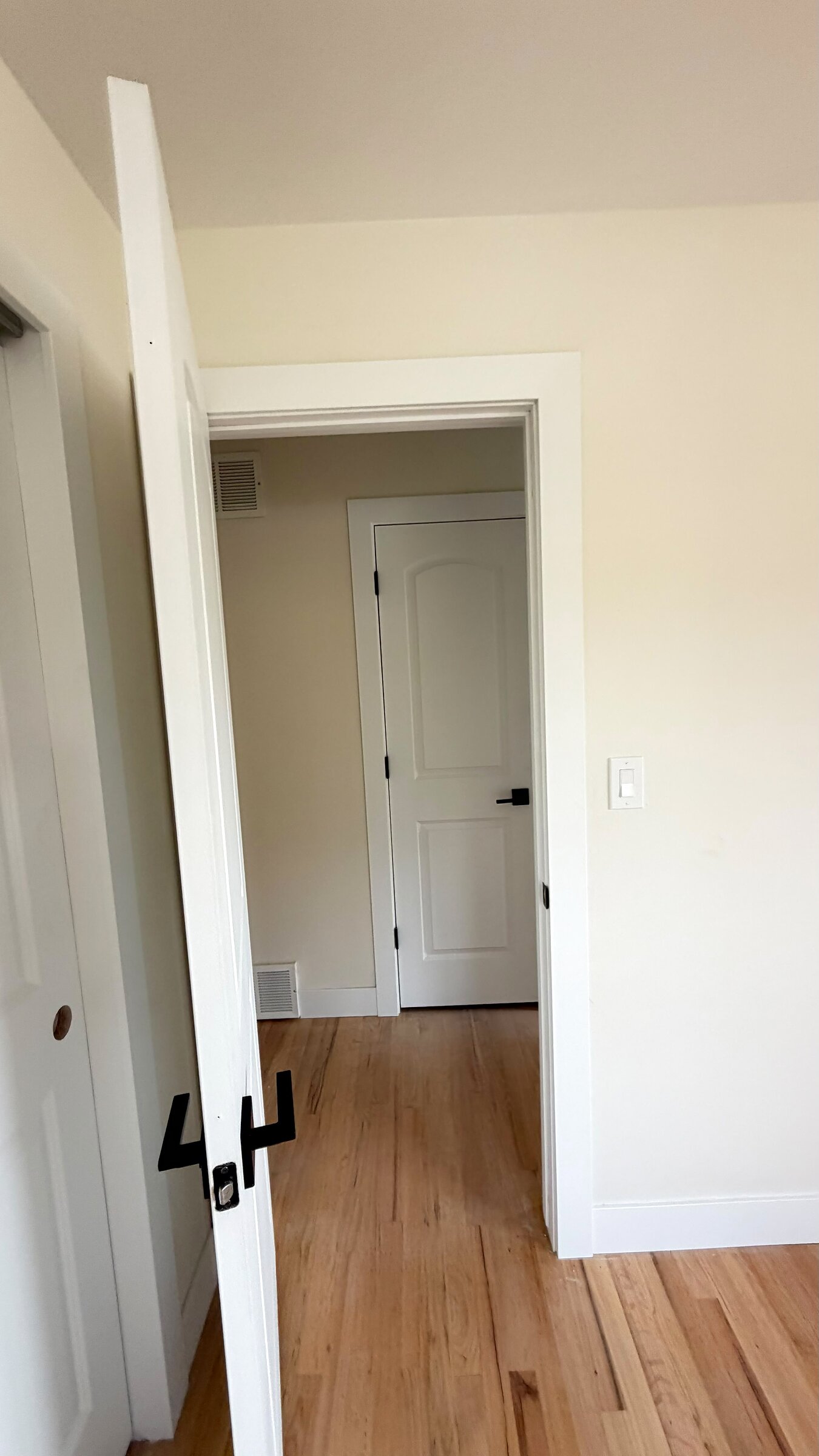 Numbered bedroom door off the hallway, refinished hardwood floors throughout