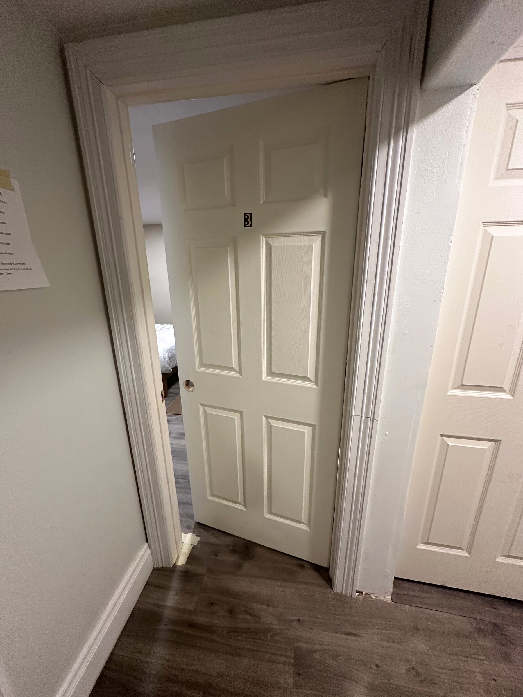 Numbered rental unit door in a hallway