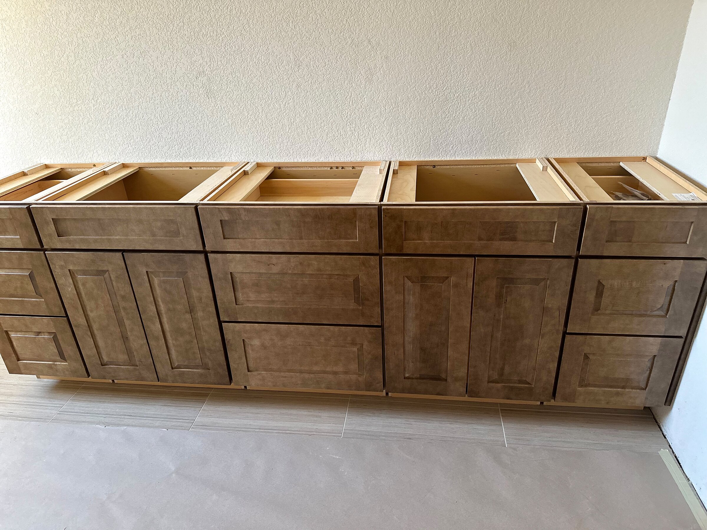 Close-up of a long cabinet bank with finished drawers and doors