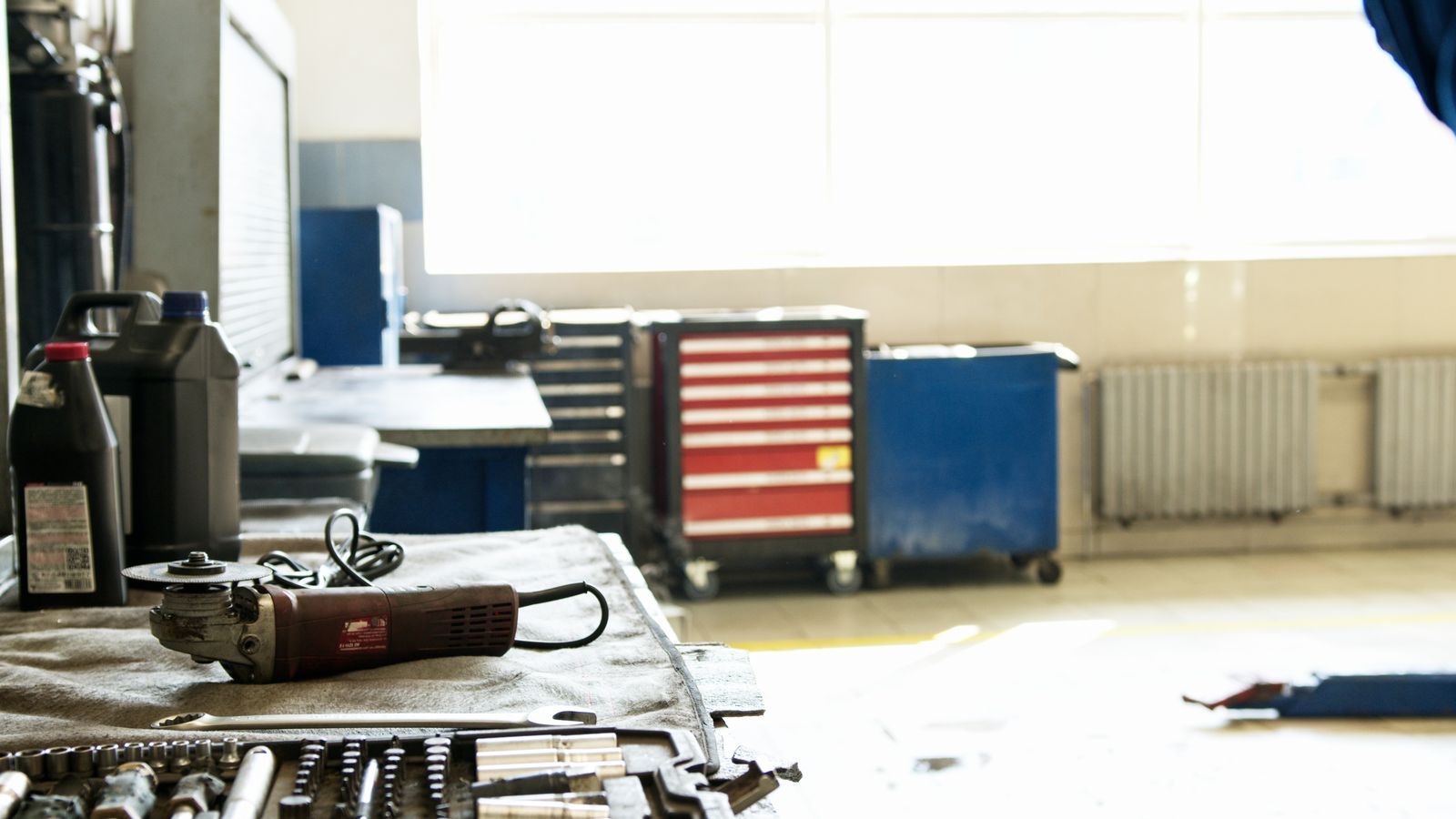 Tidy industrial workshop with a power tool resting beside a toolbox