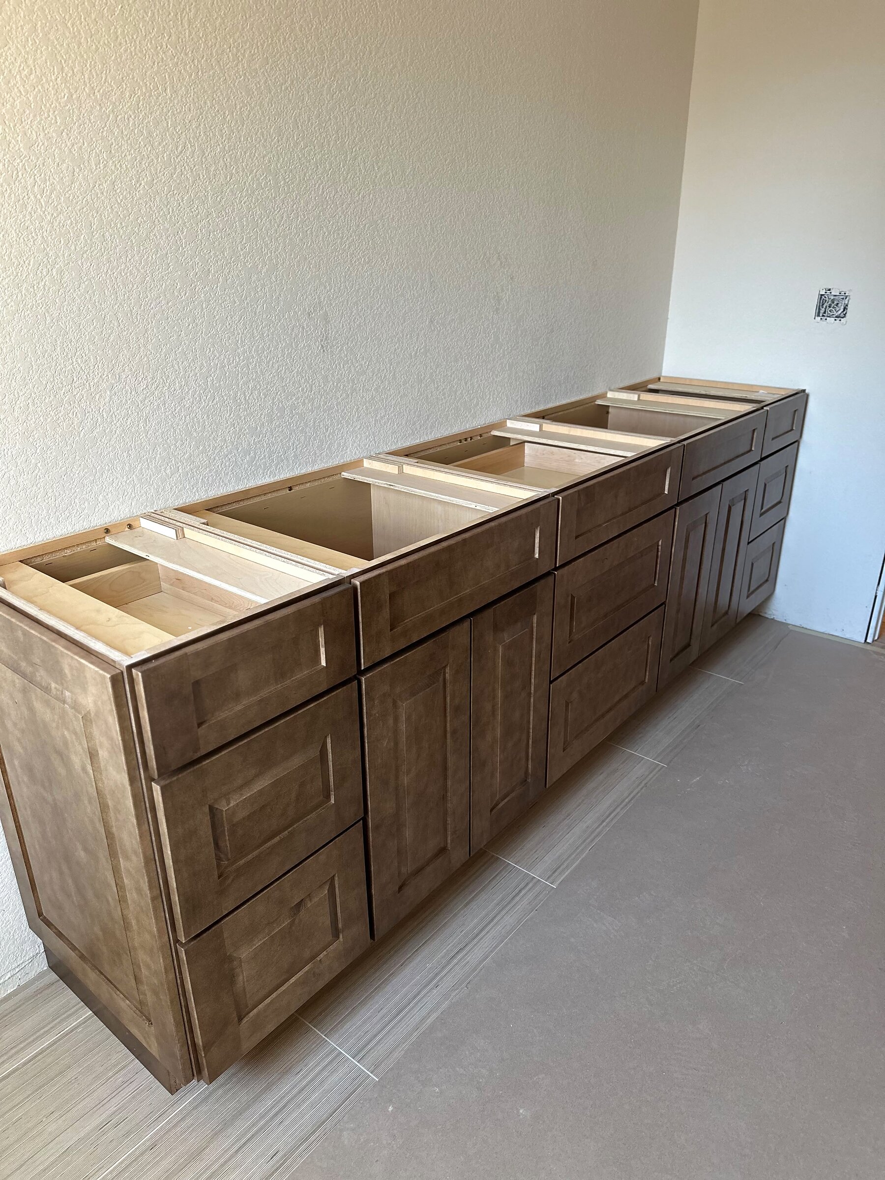 Long bathroom cabinet bank with drawers open showing finished interior