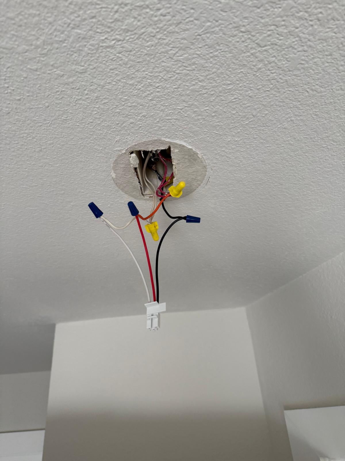 Ceiling fixture box opened up with line, neutral and switch legs capped off ready for a new light